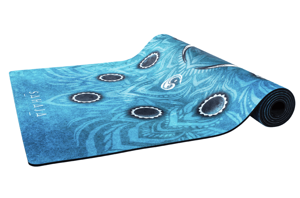 Sahaja Yoga mats that give back. Half rolled out Sahaja Crescent Moon yoga mat, blue yoga mat with the phases of the moon. Printed and beautiful yoga mats.